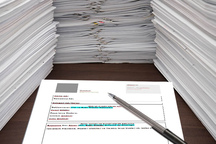 pen and blank paper besides piles of documents; Shutterstock ID 297784067