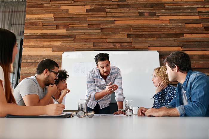 Brainstorming in a boardroom of creative office . Young creative people sitting at the table and discussing new projects.; Shutterstock ID 365534846